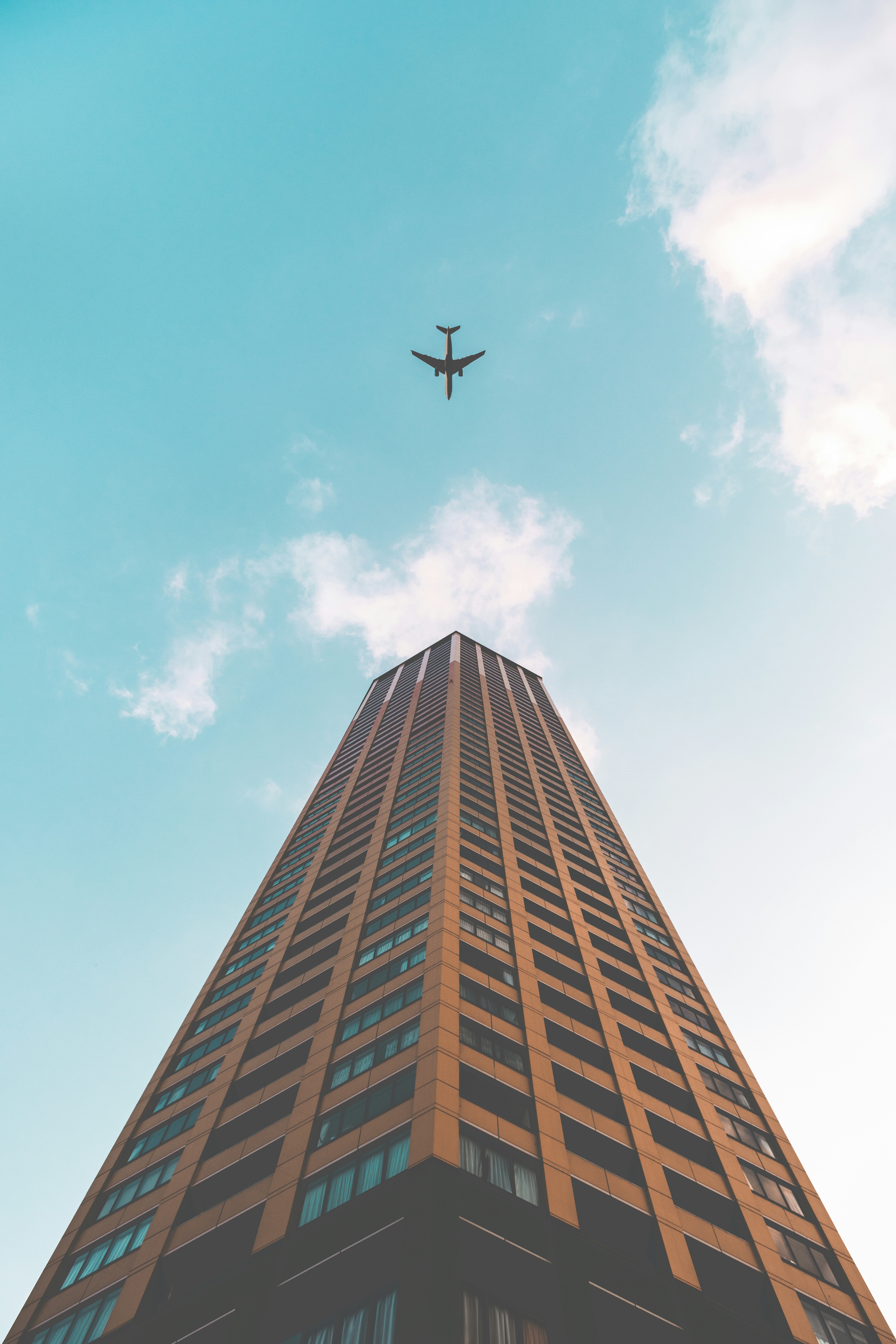 Building with an airplane flying above